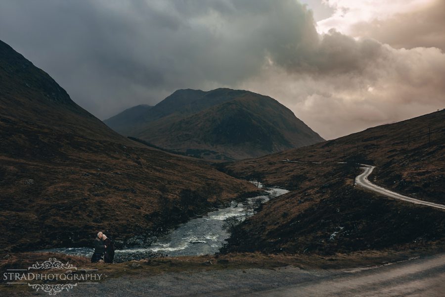 beautiful scenery, deers, elderly couple, engagement photography, glasgow photographer, glen etive, Glencoe, grandma, grandpa, hiking, kilt, landscapes, man and woman, marr, marriage, old couple, old married couple, older couple photo shoot in Glencoe Scotland, outlander, poncho, posing ideas, scotland, scottish couple, scottish highlands, senior couple, tartan