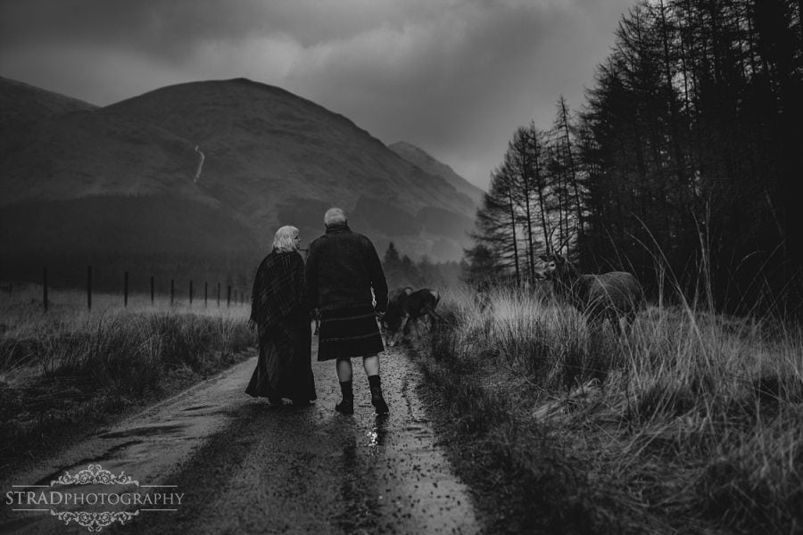 beautiful scenery, deers, elderly couple, engagement photography, glasgow photographer, glen etive, Glencoe, grandma, grandpa, hiking, kilt, landscapes, man and woman, marr, marriage, old couple, old married couple, older couple photo shoot in Glencoe Scotland, outlander, poncho, posing ideas, scotland, scottish couple, scottish highlands, senior couple, tartan