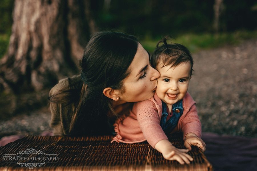 mum kisses her little daughter
