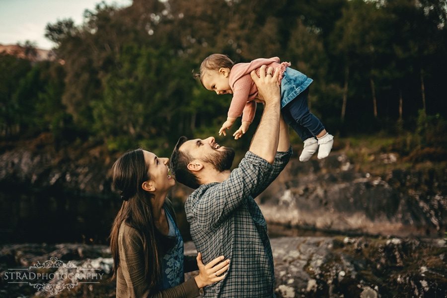father lifting her daughter in the air 