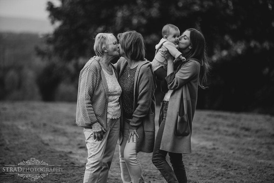 Mothers kissing their daughters