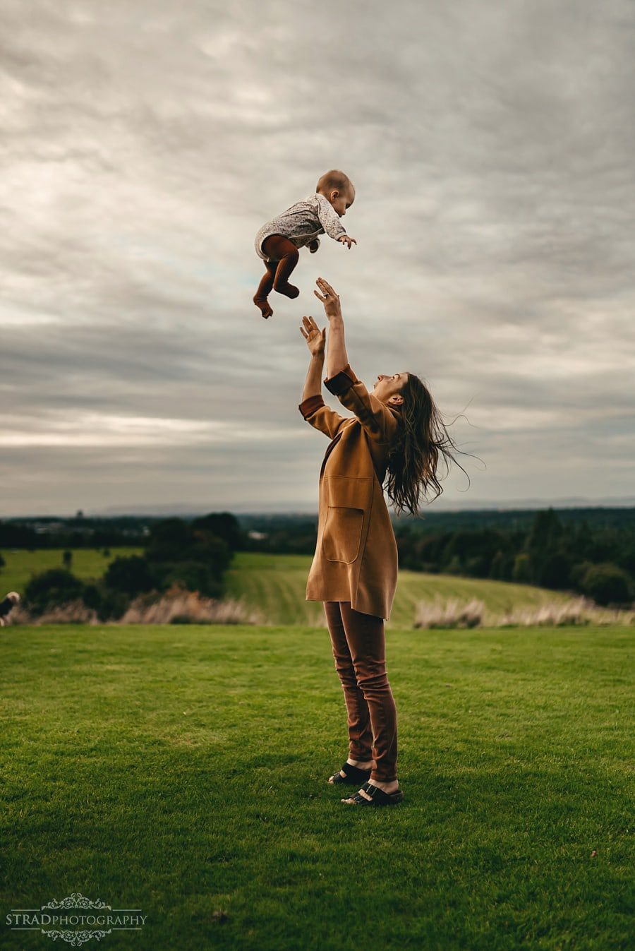 Mother throws her daughter in the air