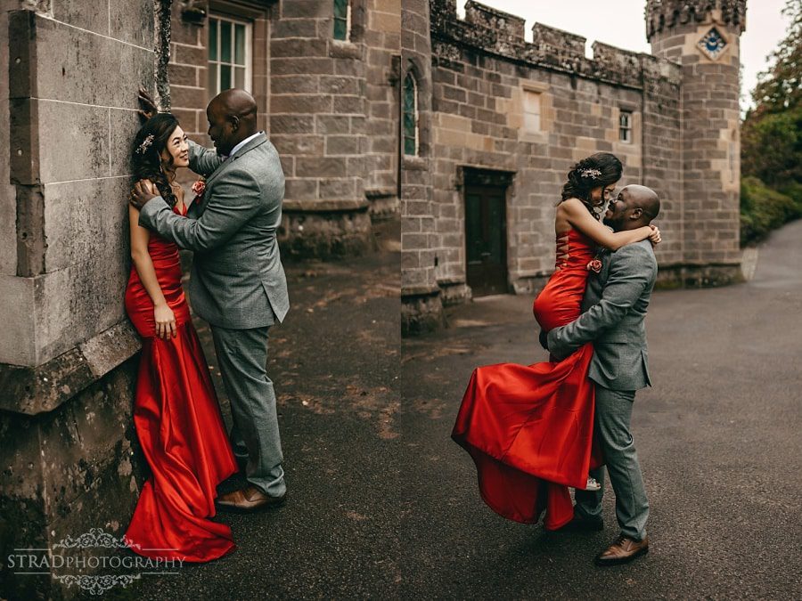 Groom lifts up the bride in the red dress up 