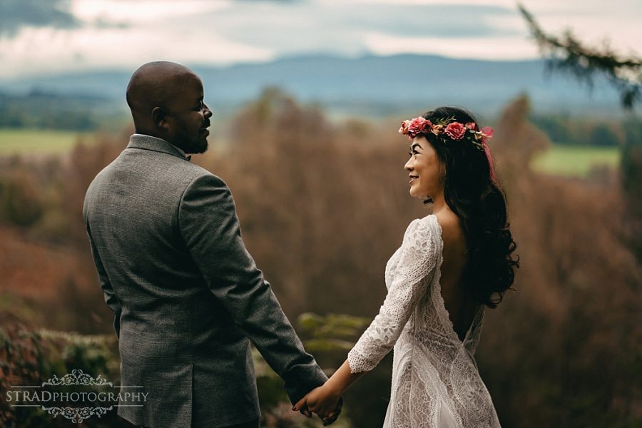 Bride and groom's holding hands together and looking at each other