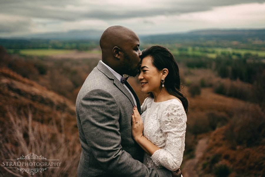 Groom kisses the bride in the forehead