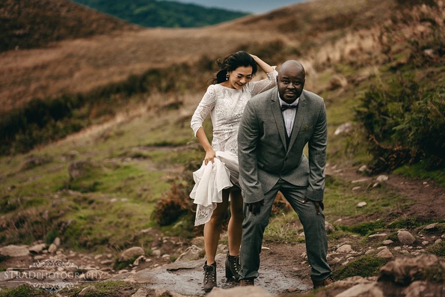 Bride jumps on the grooms back 
