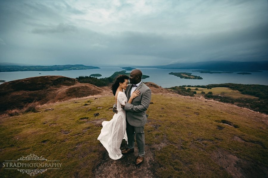 Wide angle photo of the bride and groom on the top of Conic Hill