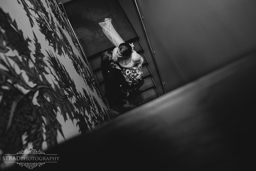 Bride and groom kisses at the stairs of the Bothy