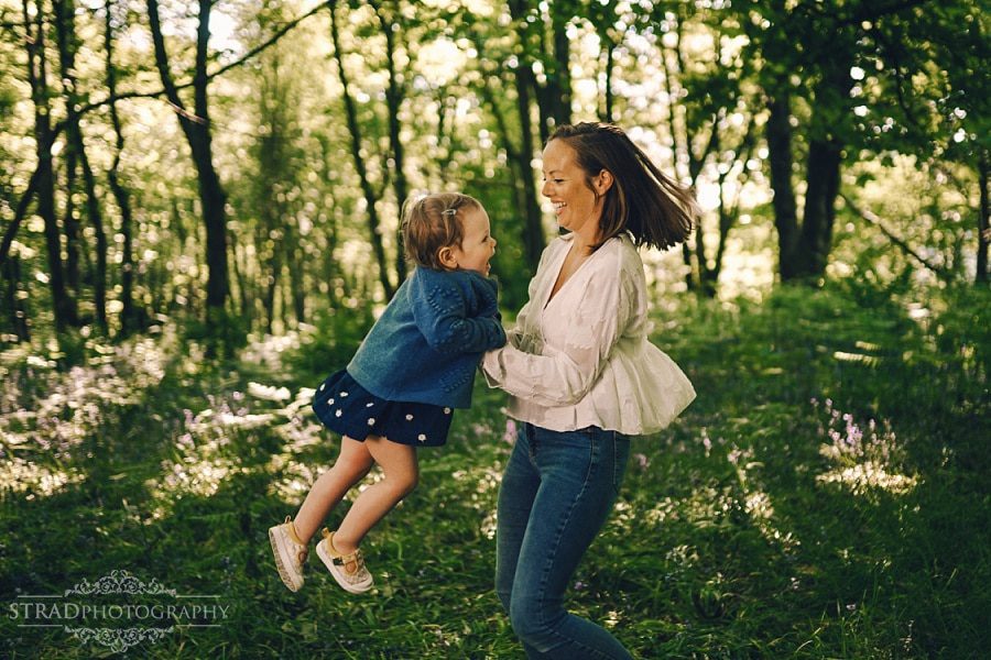 Mother spins her daughter.