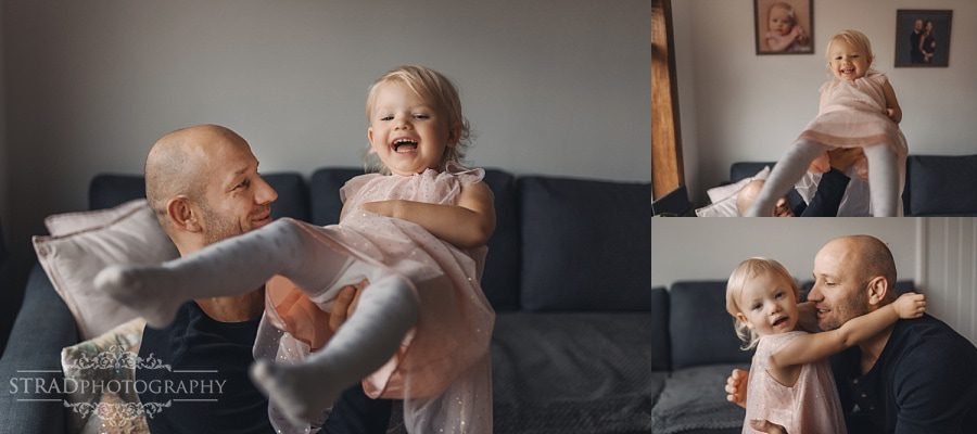 Father playing with his daughter in their home
