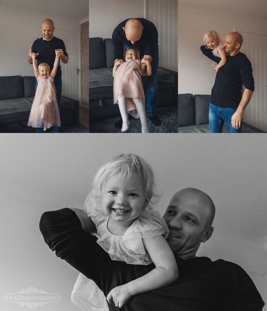 Father playing with his daughter in their home