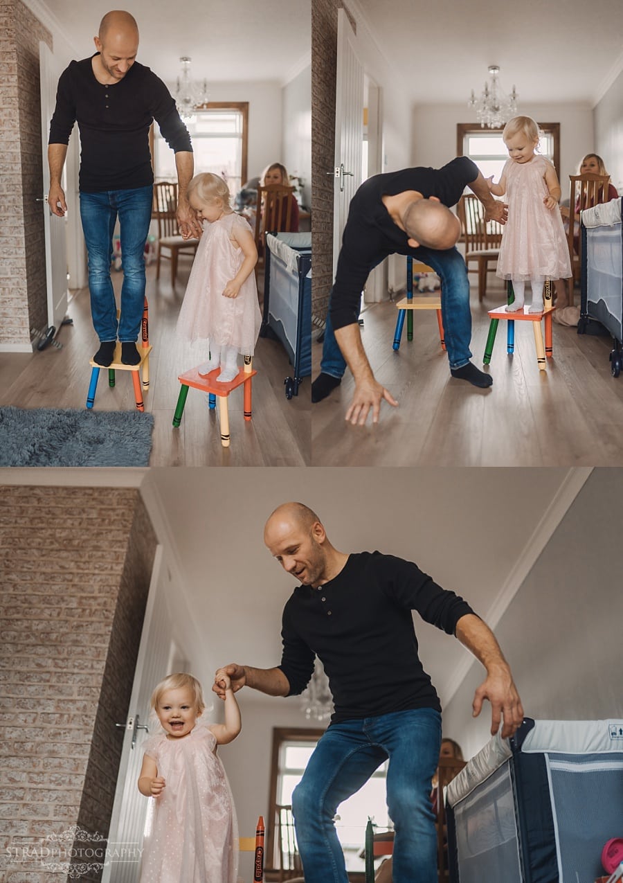 Father playing with his daughter in their home