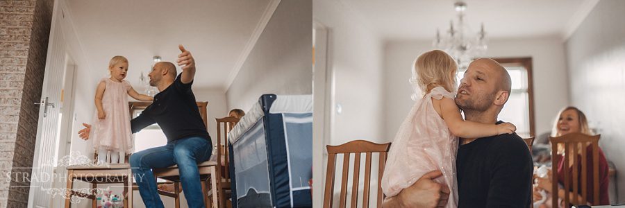 Father playing with his daughter in their home