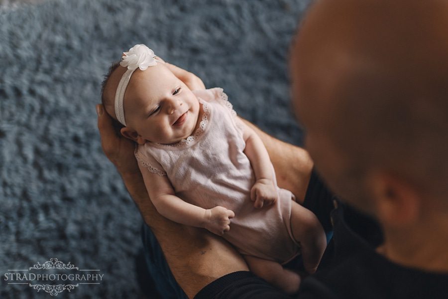Father holds his newborn daughter in his arms