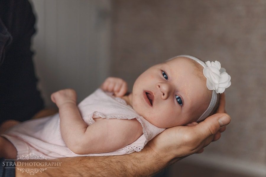 Father holds his newborn daughter in his arms