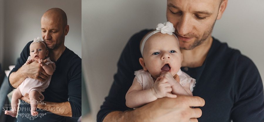 Father holds his newborn daughter in his arms