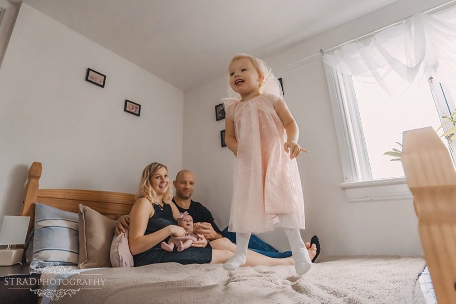 Little girl jumps on the bed