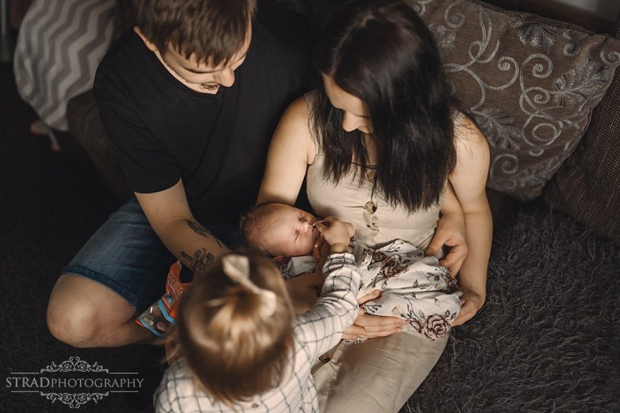 sister giving newborn haribo