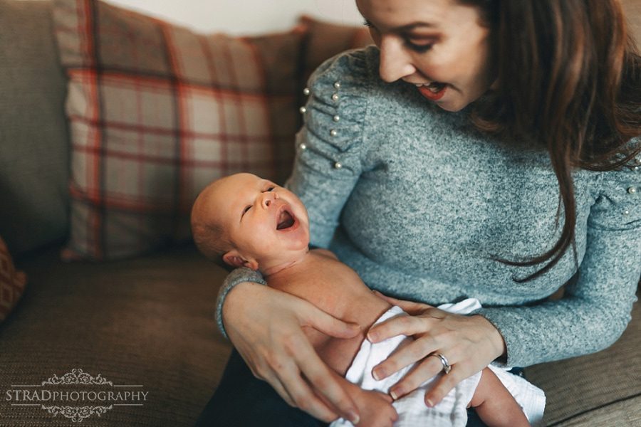 newborn baby boy yawns with his mother