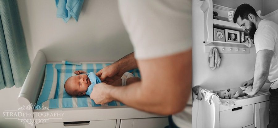 Father changing the nappy of his newborn baby boy
