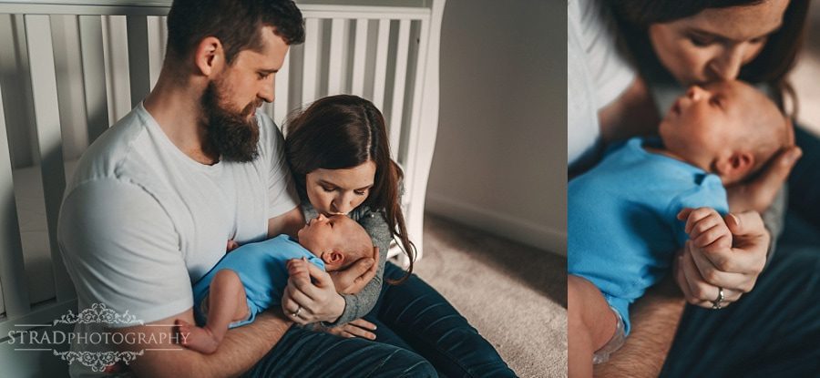 Mother kisses her newborn baby son
