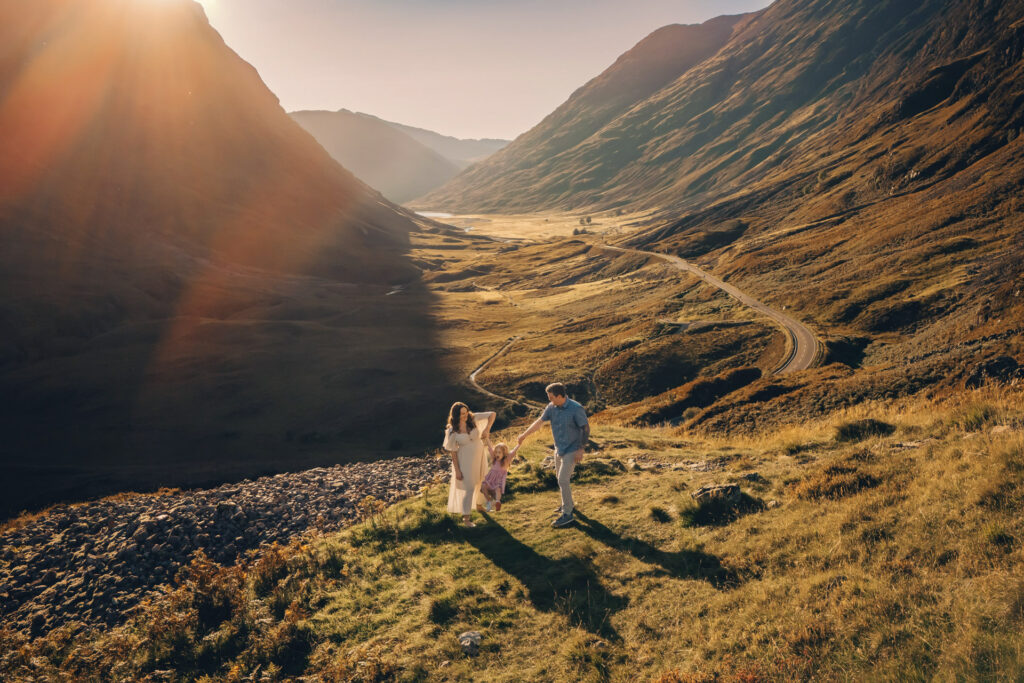 Aerial summer photo of parents swinging their daughter near Three Sisters of Glencoe 