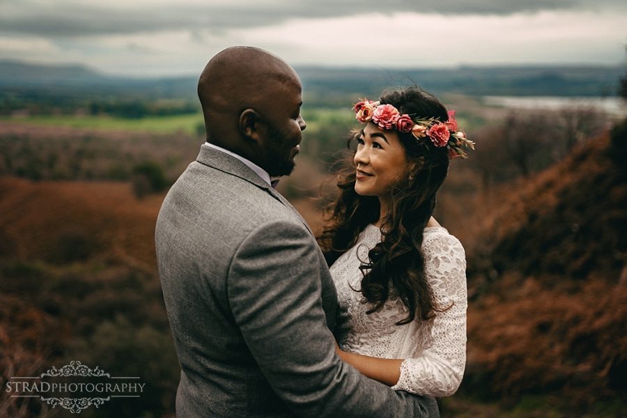Bride and groom looking at each other on the way to Conic Hill