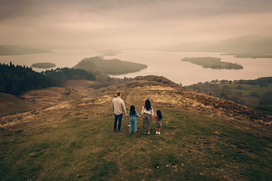Aerial photo of a family at Conic Hill enjoying the view over Loch Lomond.