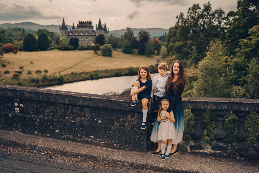 Mother with her 3 children sitting on Array Bridge near Inveraray Castle.