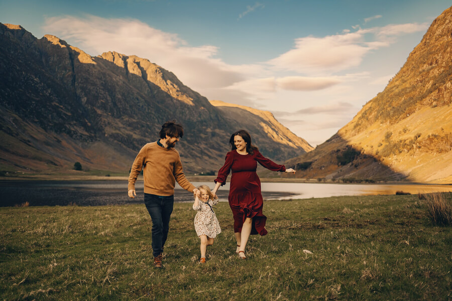 Family of 3 running together near Loch Achtriochtan.