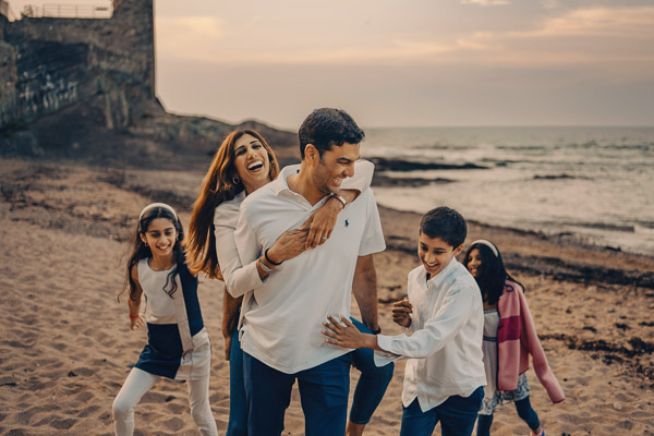 Wedding & family photographer in Scotland captures a family having fun o the beach in St andrews