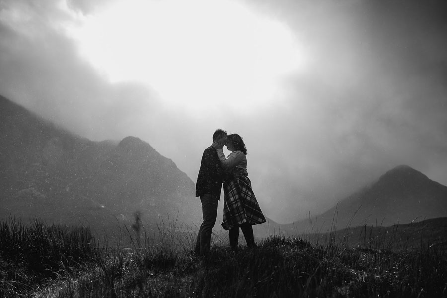 Couple kissing in dramatic landscape