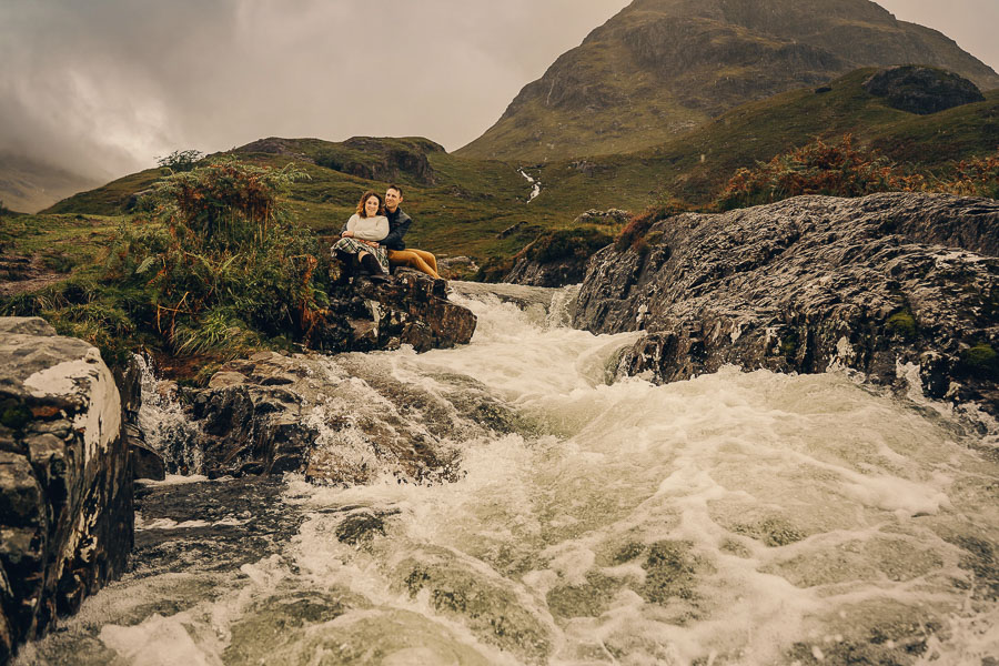 Couple by rushing river in Scotland