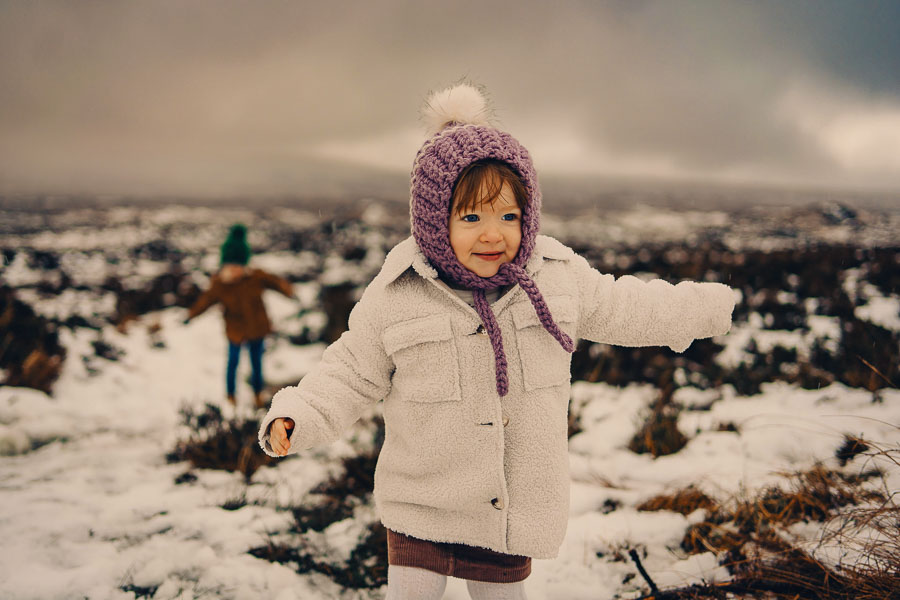 Children playing in snowy landscape.