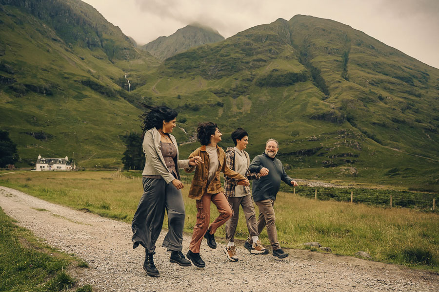 Group walking in scenic Scottish landscape.