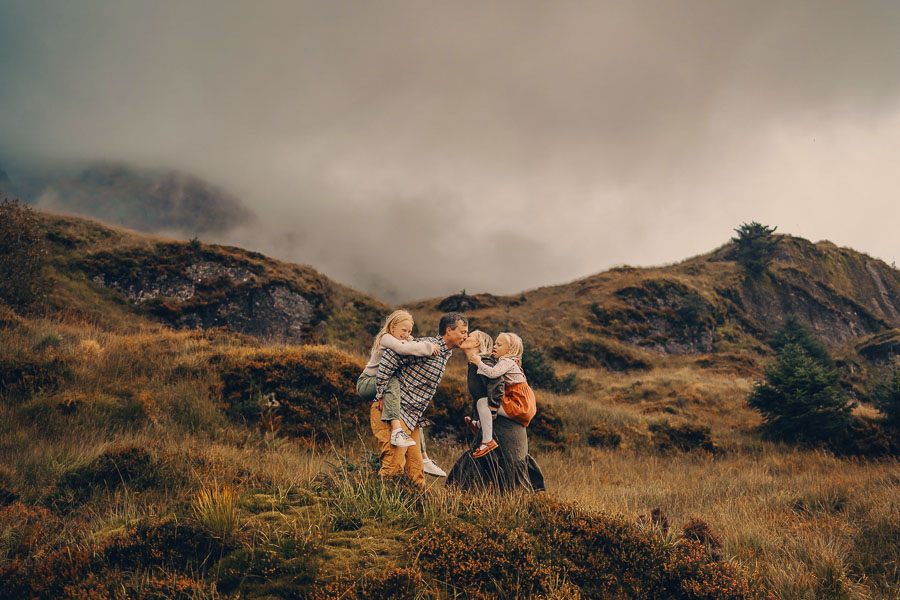 Family hiking in moody landscape.