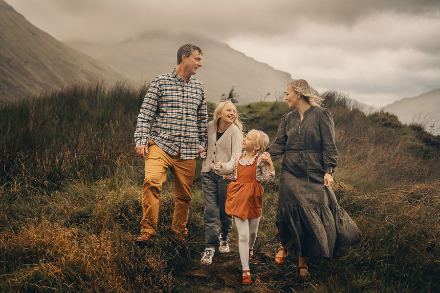 Family walking in moody landscape.