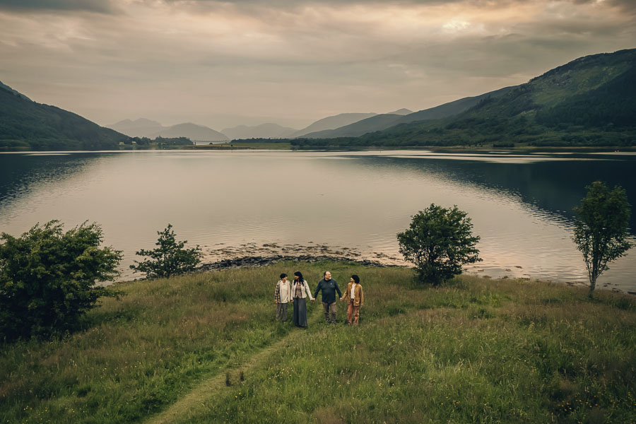 Group walking by serene loch