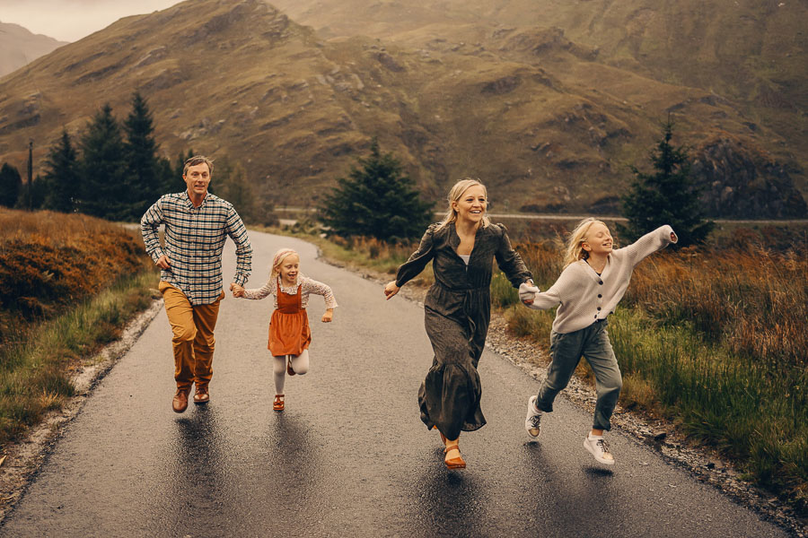 Family running joyfully in nature.