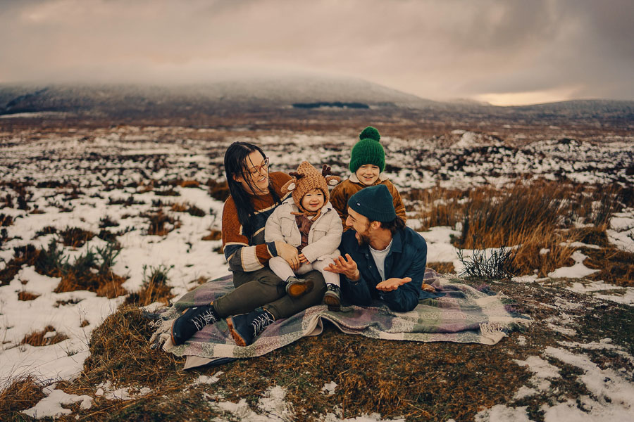Family enjoying a snowy landscape together.