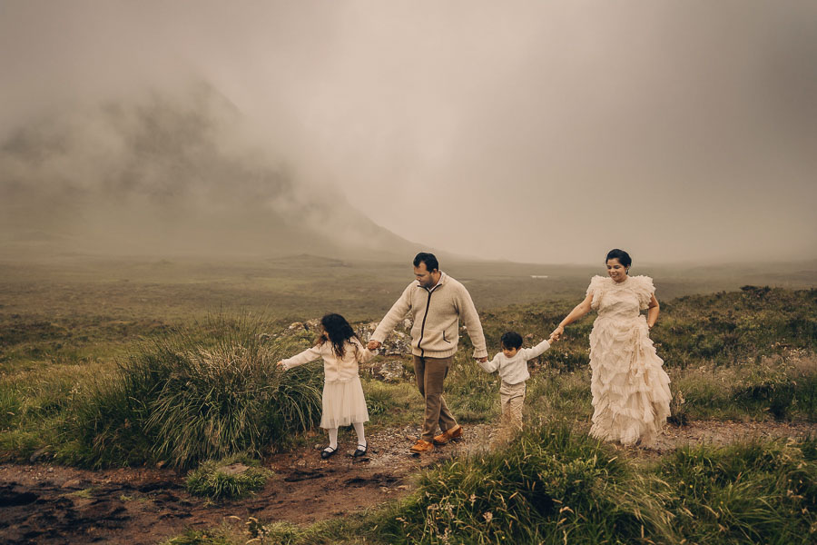 Family walking in misty landscape.