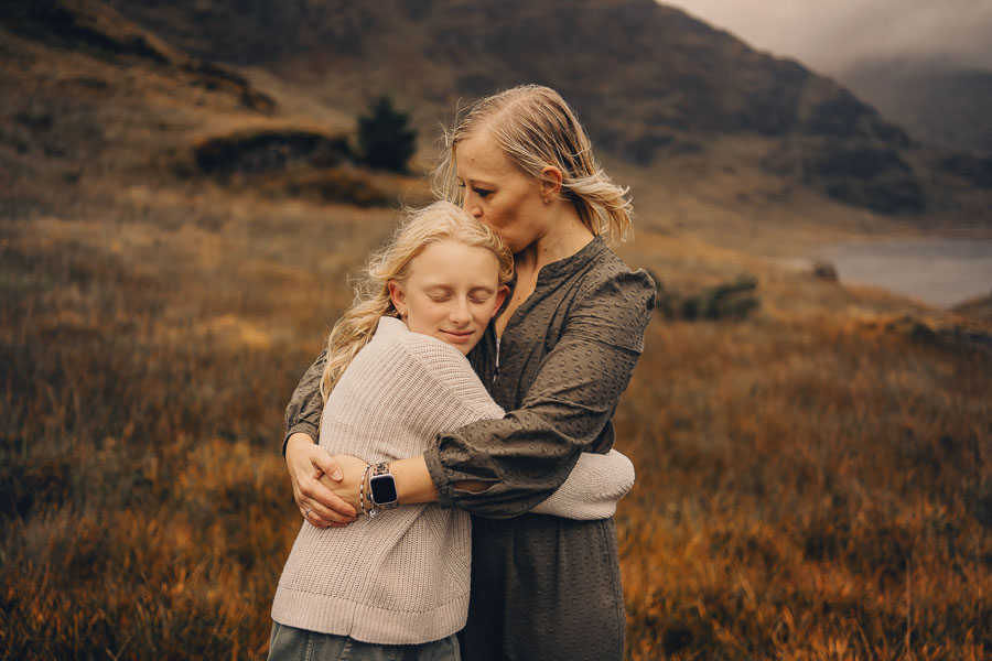 Two people embracing in nature.