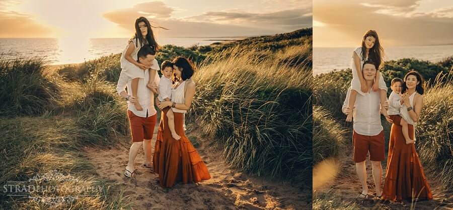 Family walking through sandy dunes at Irvine Beach during sunset