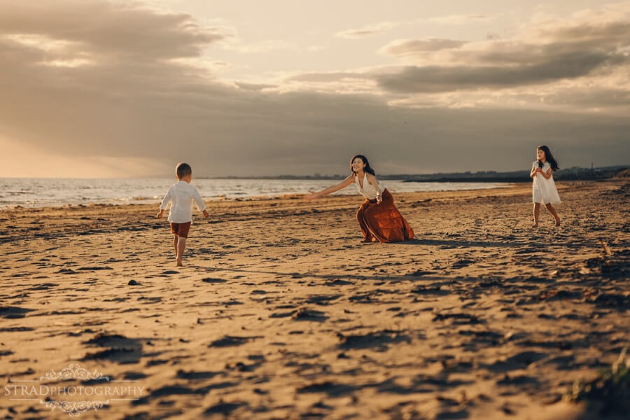 boy running to his mother at the beach
