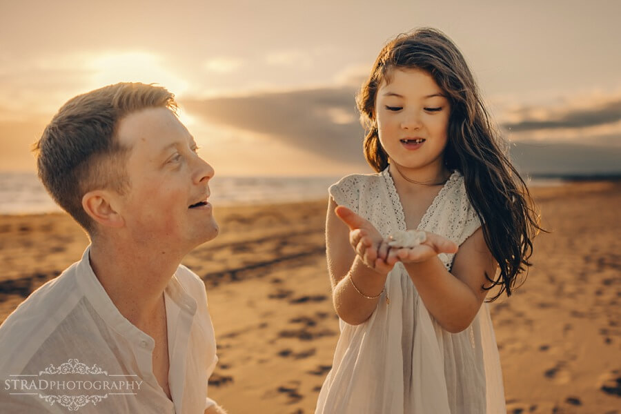daughter showing her dad shells she found