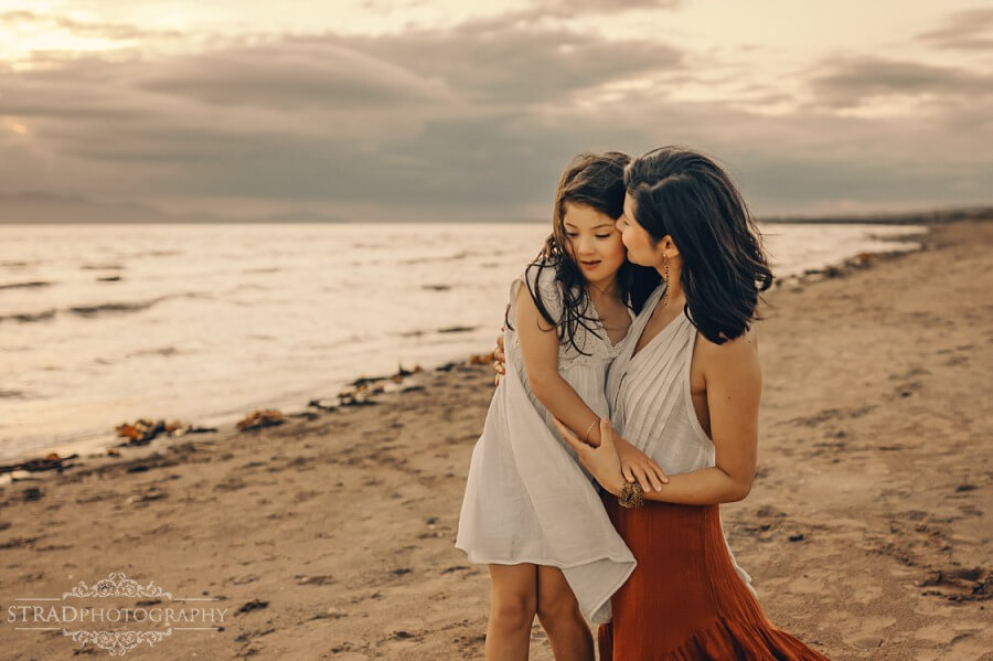 mother cuddling with her daughter