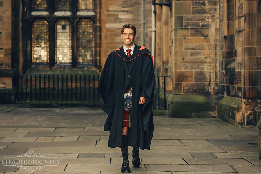 Graduate walking in academic gown.