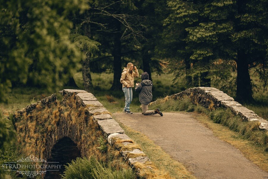 man proposing to his girlfriend on Butter Bridge, Scotland