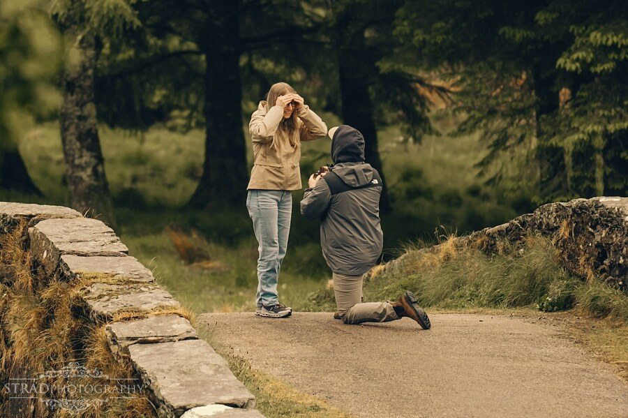 man proposing to his girlfriend on Butter Bridge, Scotland