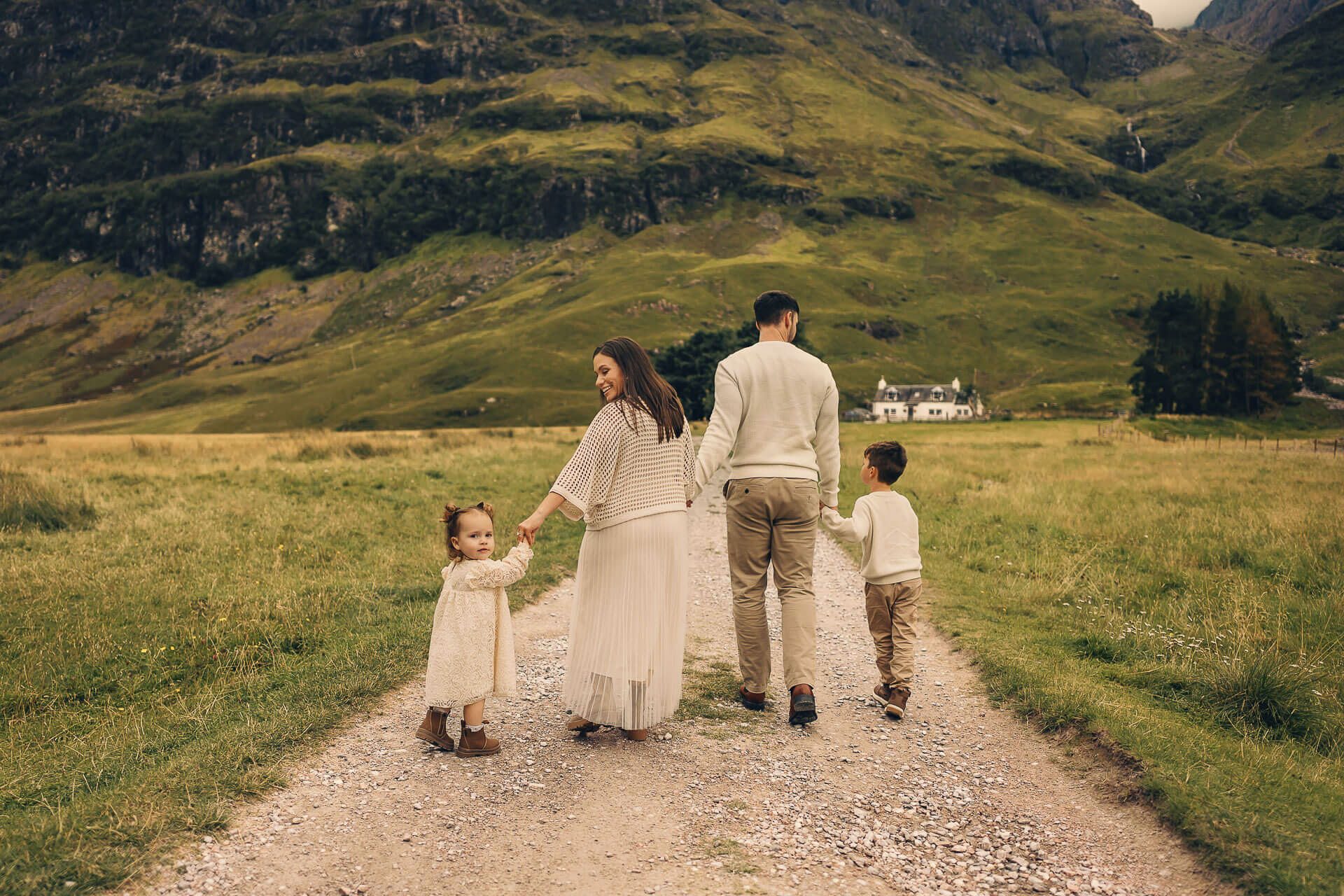 Family walking through scenic countryside.
